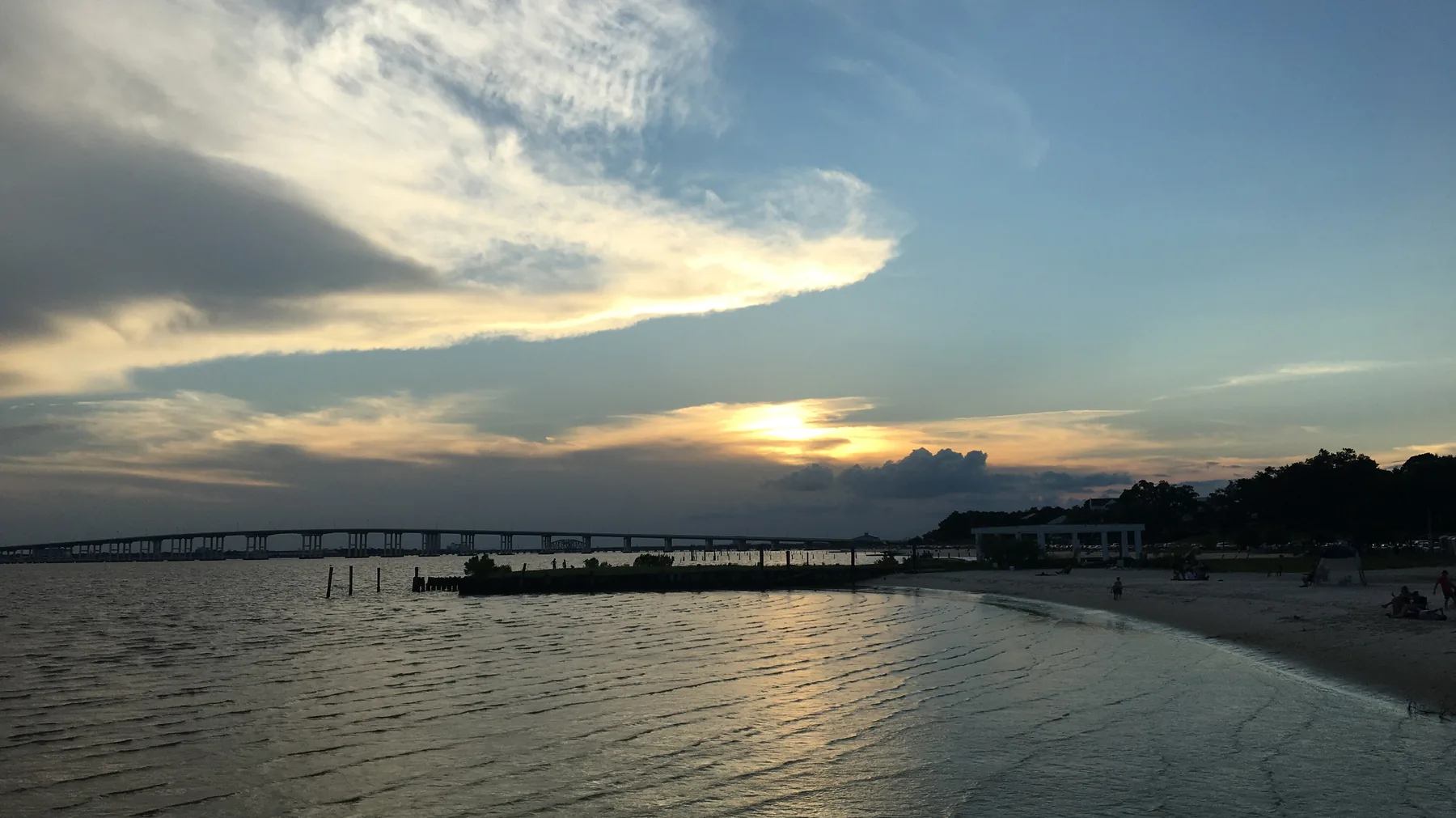 Front Beach in Ocean Springs, Mississippi, looking out over Biloxi Bay toward the Biloxi Bay Bridge at sunset